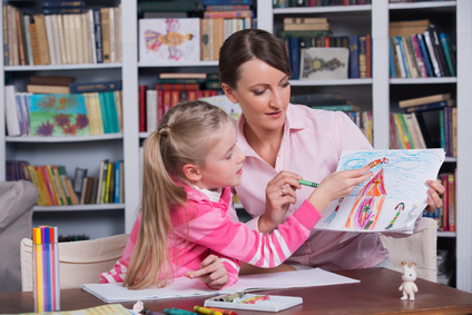 Child psychologist with a little girl, a child draws